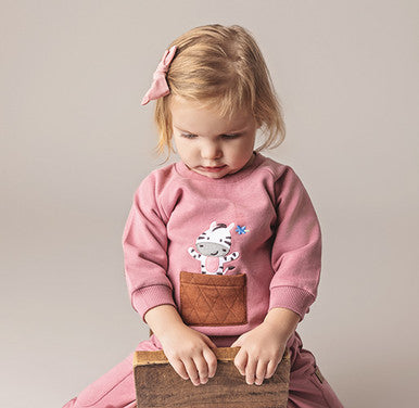 Young girl wearing Pink Sweatshirt